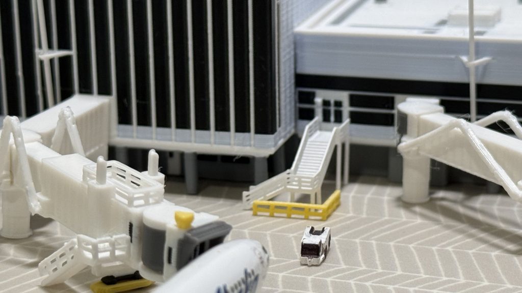Close-up of 1:400 scale jetbridge stairs, ground service equipment, and terminal building detail